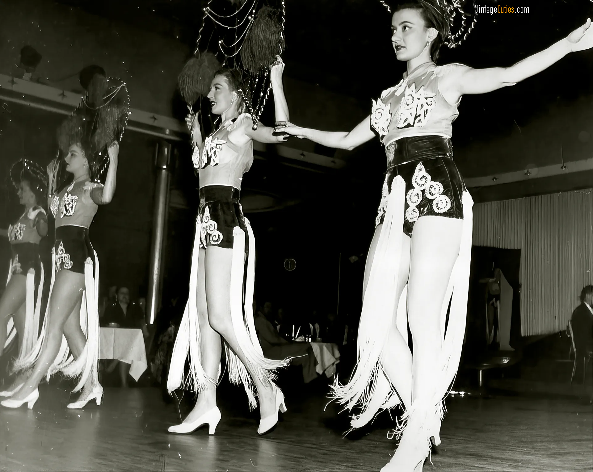 Beautiful vintage girls dance in a burlesque theatre