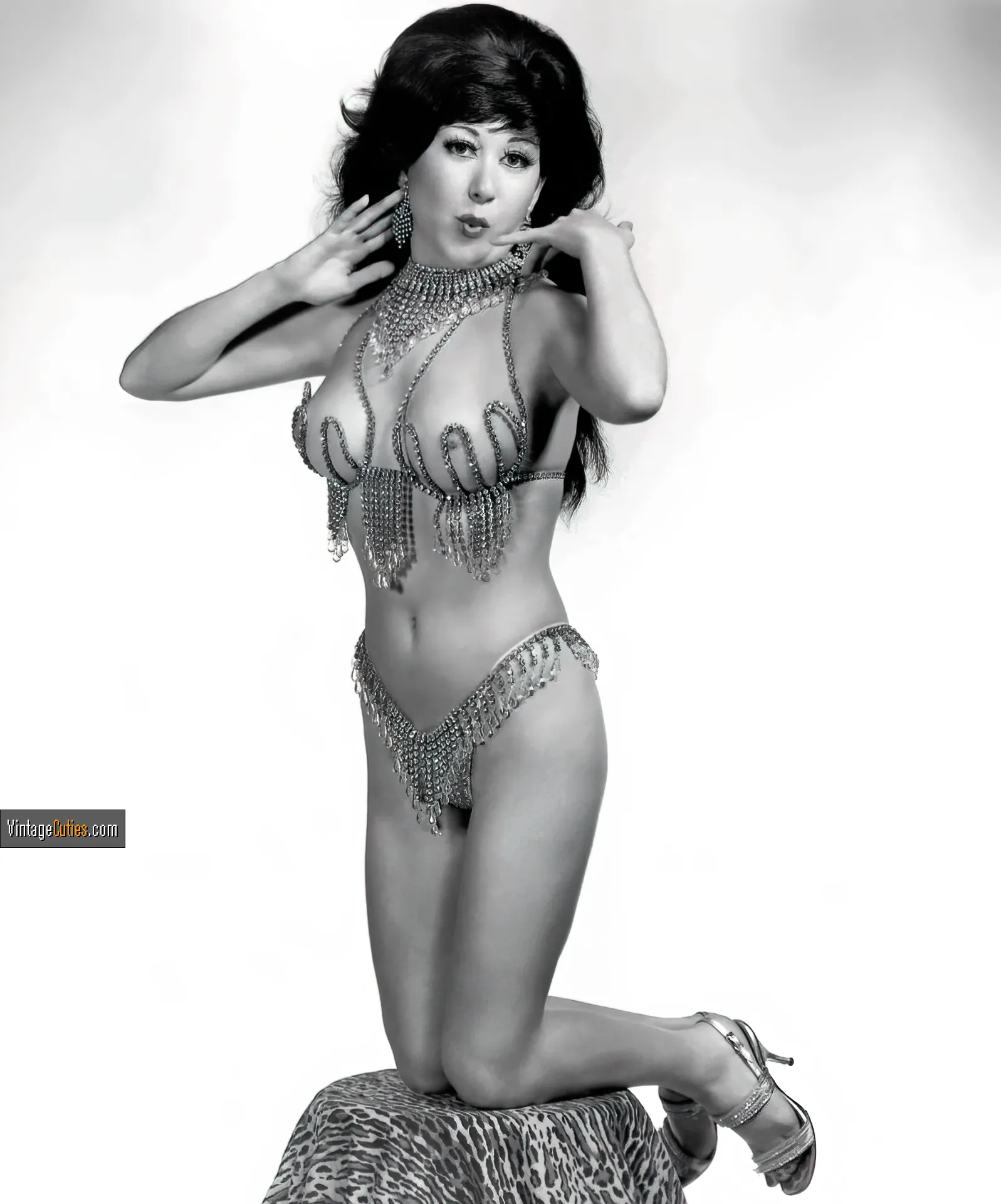 Brunette in a vintage burlesque bikini with her boobs peeking out