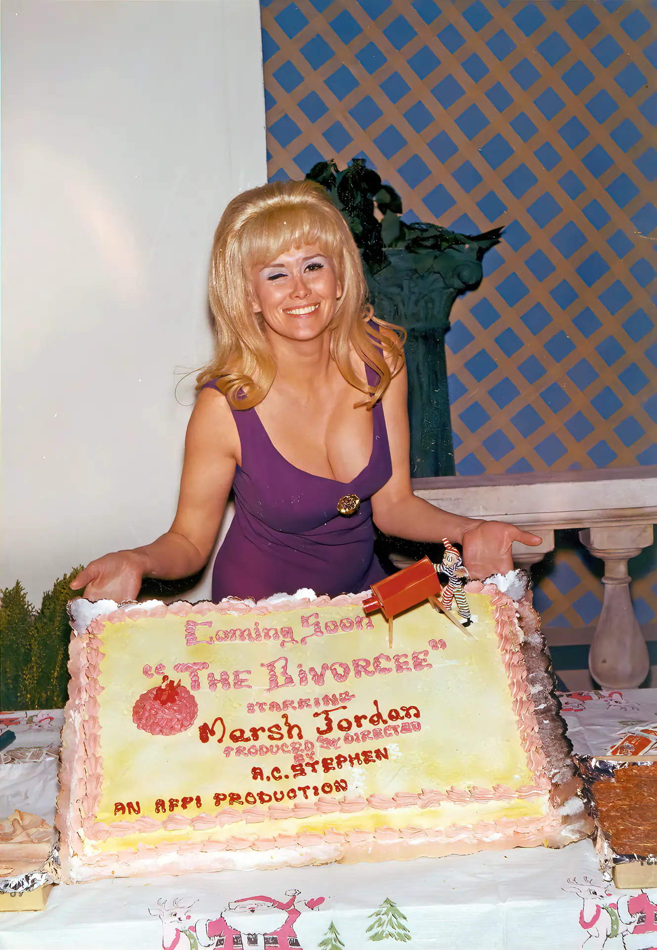 Sassy blonde Marsha Jordan seductively winking in her purple dress